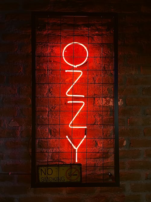 Free Neon Sign on a Brick Wall Stock Photo