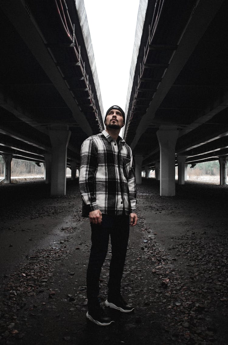 Young Man Standing Under Bridge