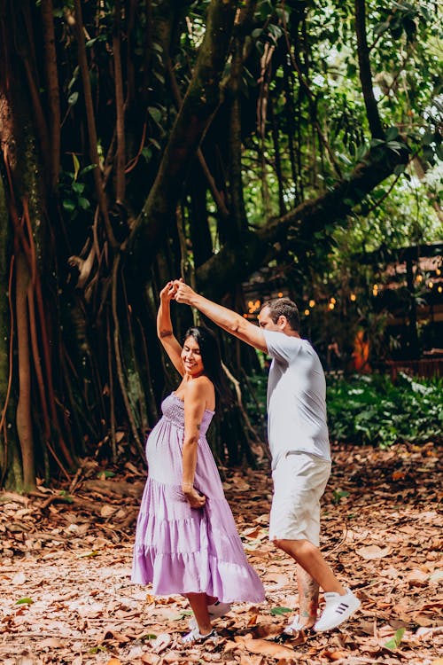 Man Holding Hands with Woman in Dress