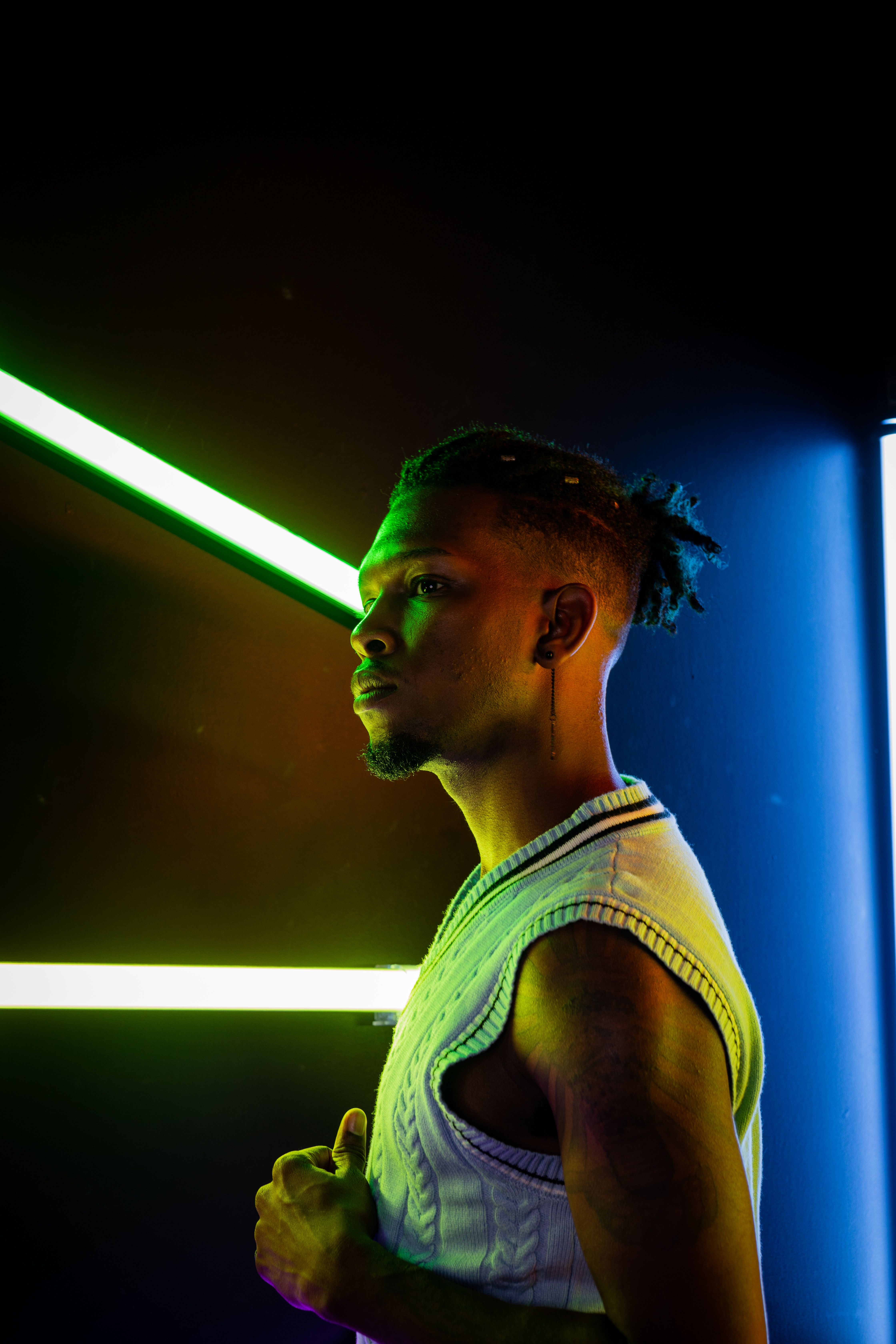 A man standing in front of a neon light · Free Stock Photo