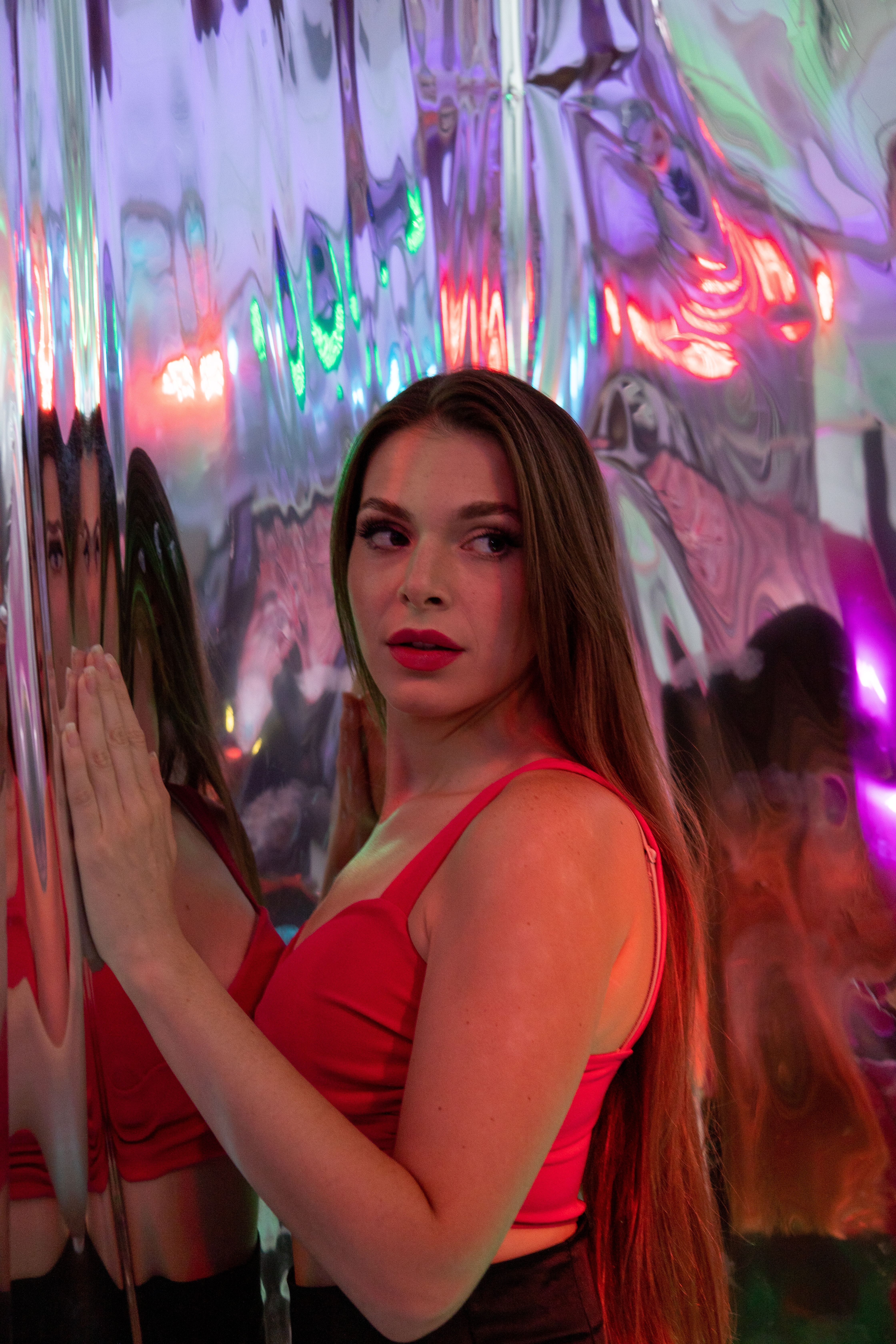 Woman in Red Top Posing by Shiny Wall · Free Stock Photo