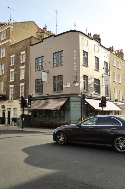 Stylish city intersection with historic architecture and car passing by.