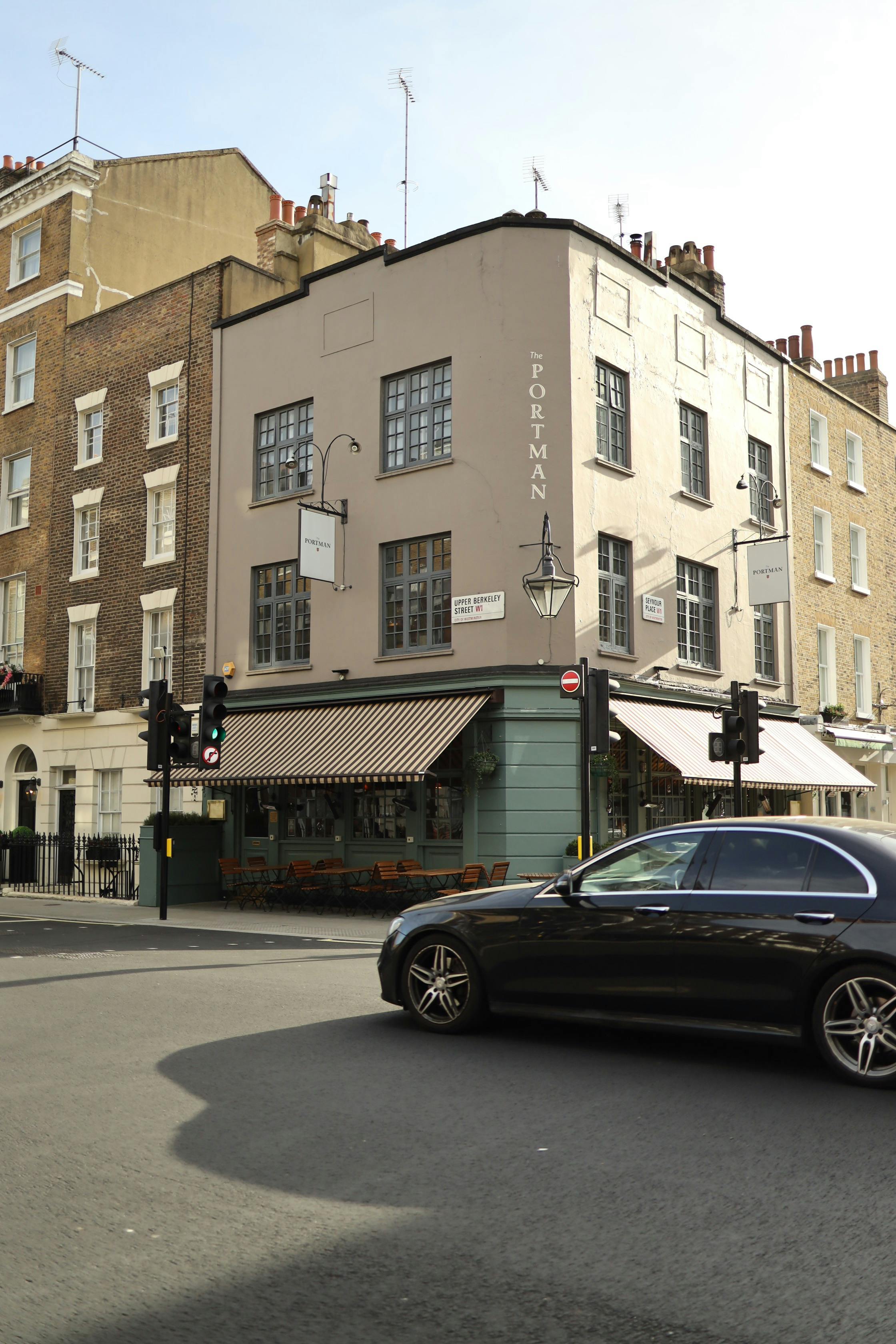 Free Stylish city intersection with historic architecture and car passing by. Stock Photo