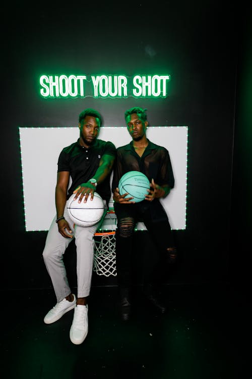 Two Men Holding Basketballs