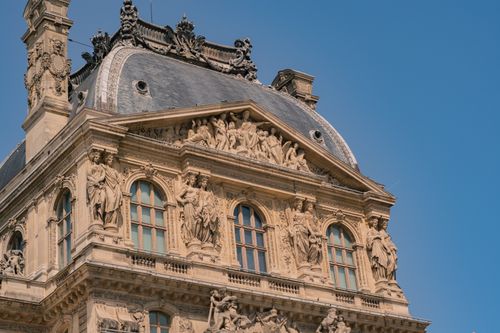 Free Detailed view of the baroque architecture and sculptures of the Louvre Museum in Paris, France. Stock Photo