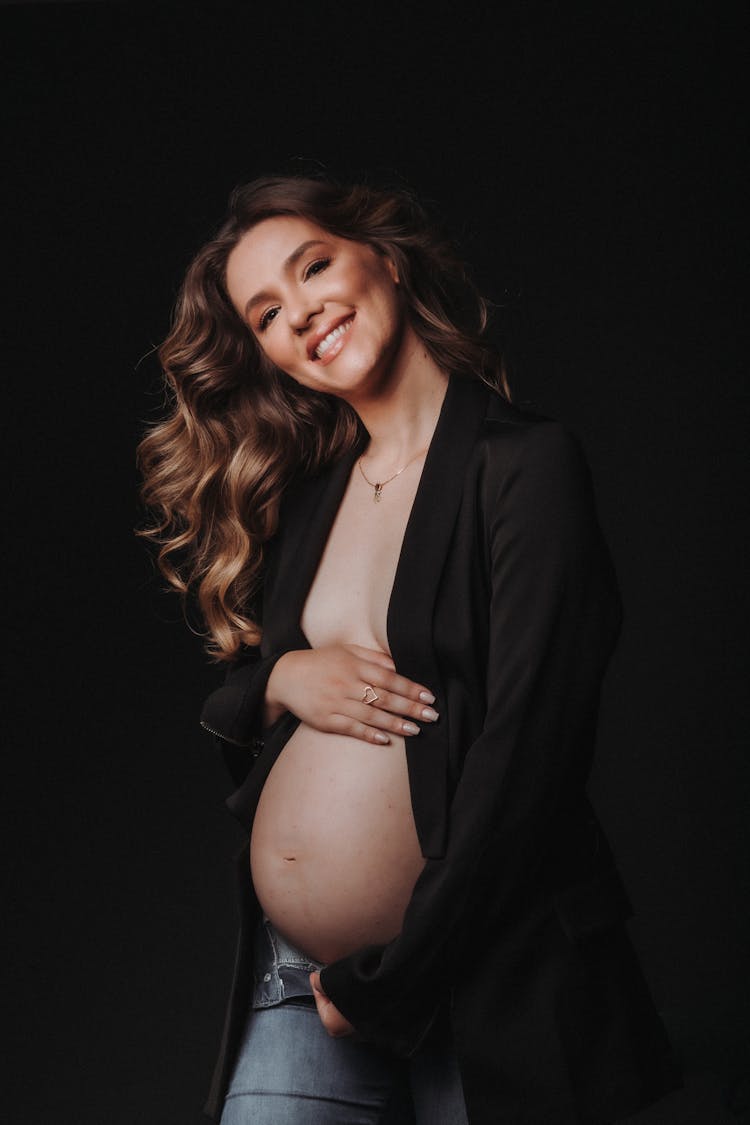 Smiling Pregnant Woman Wearing Opened Black Shirt