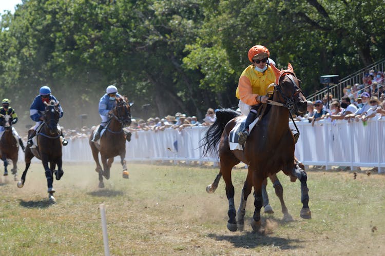 Men Racing On Horseback