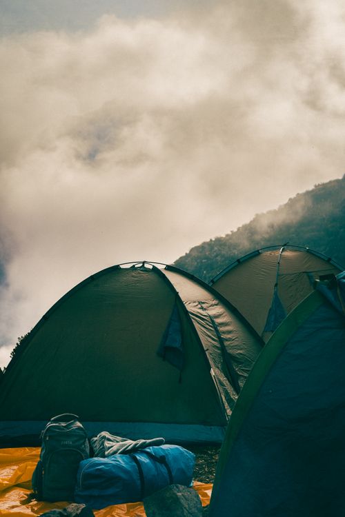 Free Serene campsite with tents nestled in the mountains of Huaral, Peru. Perfect for nature enthusiasts. Stock Photo