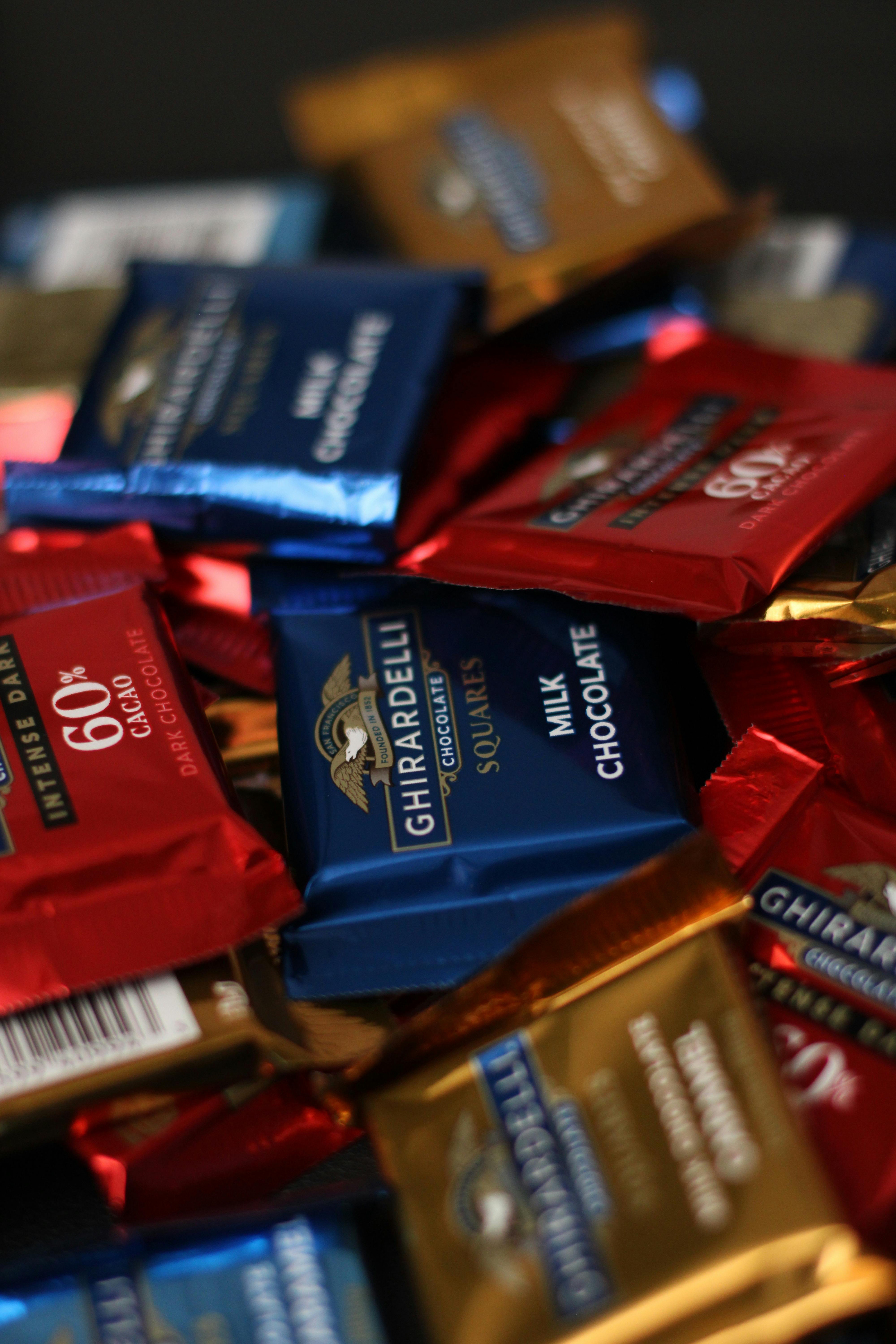 a pile of chocolate bars with different colors