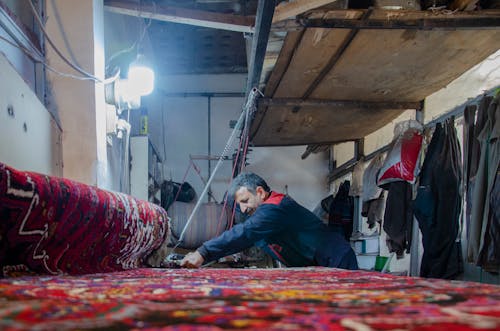 Man at Workshop Manufacturing a Rug