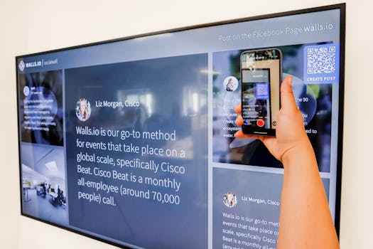 Hand holding smartphone scanning QR code on a large digital display. Technology and connectivity concept.