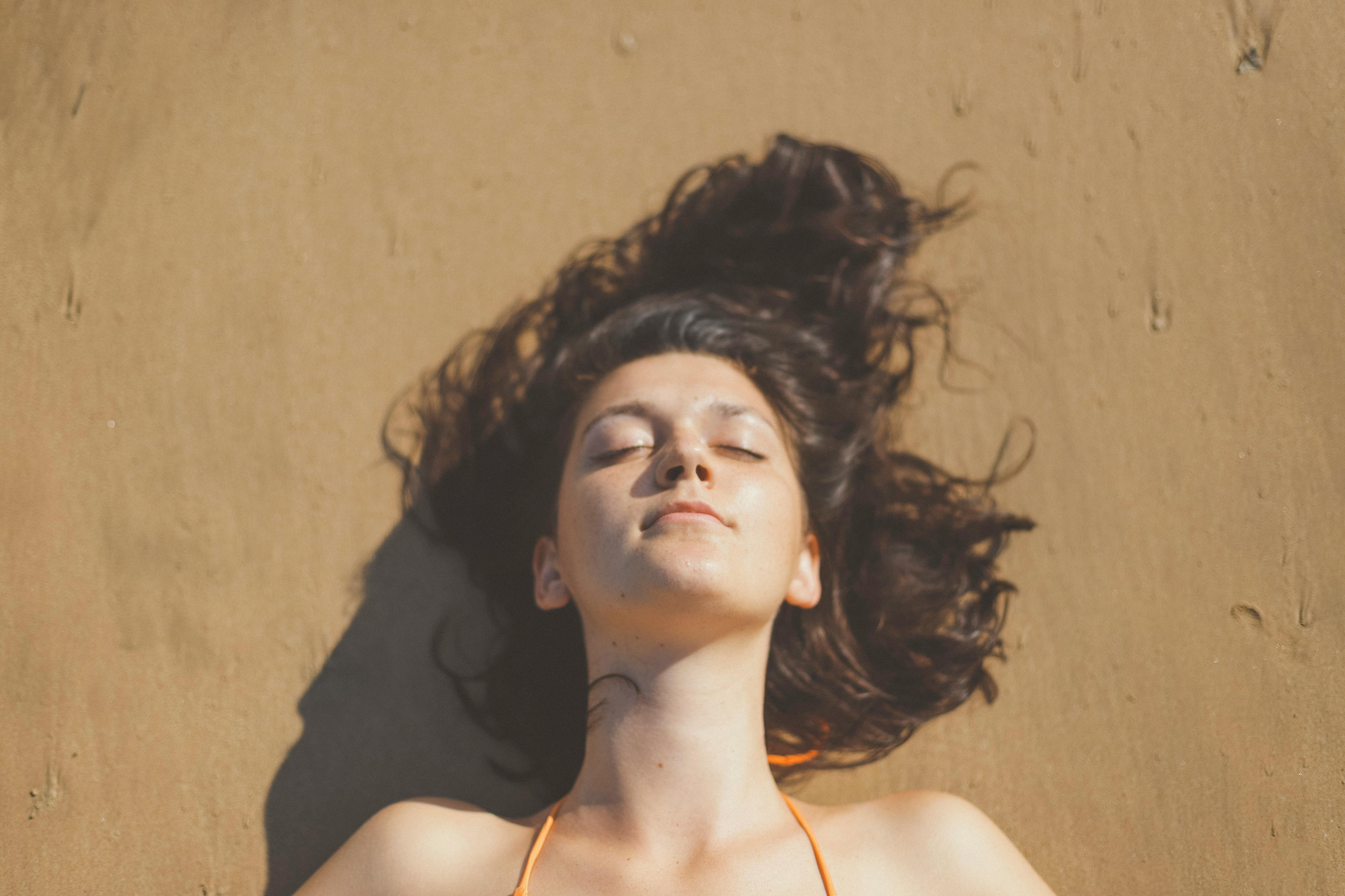 Overhead Shot of a Girl Lying on the Sand