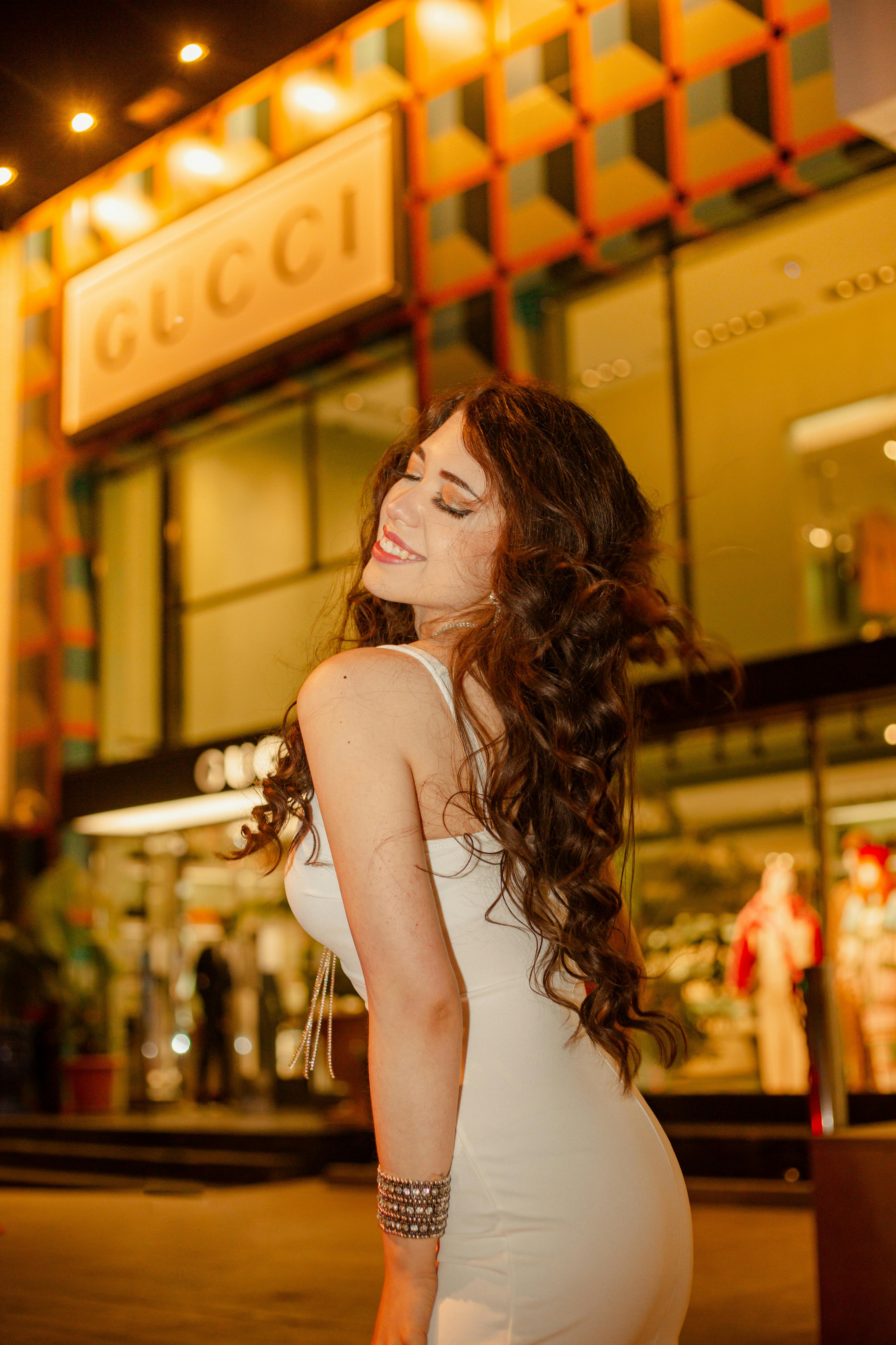 Free Photos - A Stunning Woman Wearing A White Dress, Likely A Bridal Gown,  As She Poses In Front Of A Blue Door. She Is Leaning Against The Door,  Holding A Handbag,