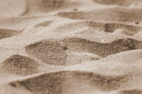 Free A detailed close-up of textured sand dunes showcasing arid and barren desert landscapes. Stock Photo