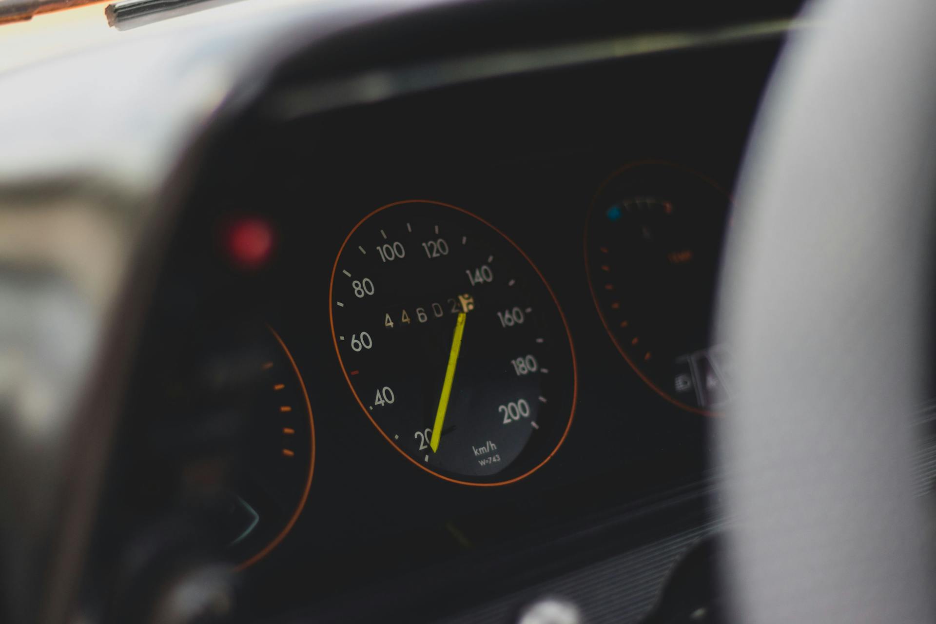 Detailed view of a car speedometer showing speed and mileage with selective focus.