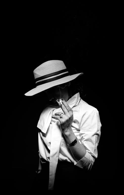 Grayscale Photo of a Woman Smoking 