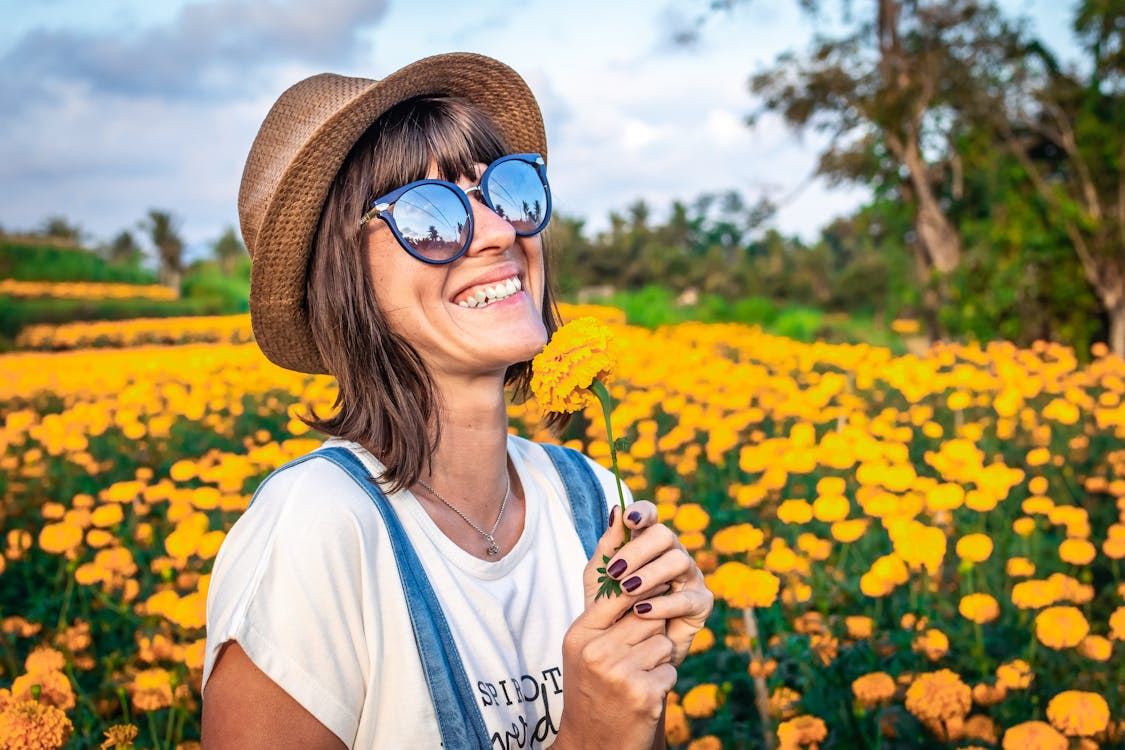 Woman in sunglasses in flower field