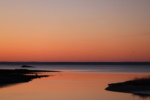 Free Vibrant sunset over ocean at Cove Island Park, Stamford, CT. Perfect seascape with red sky reflection. Stock Photo