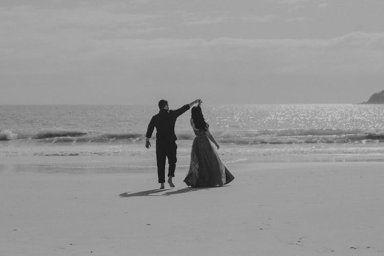 A Couple Dancing On The Beach 