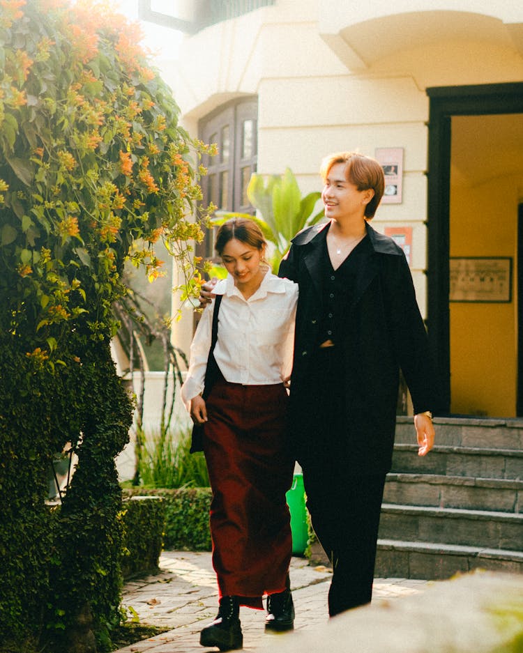 Smiling Couple Hugging Walking Near House