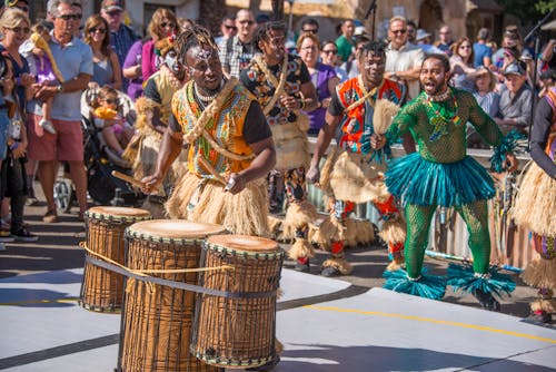 Men in Traditional Costumes Playing on Drums on City Festival