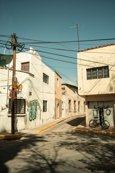 A vintage street corner with rustic buildings and a parked bicycle, showcasing urban charm.