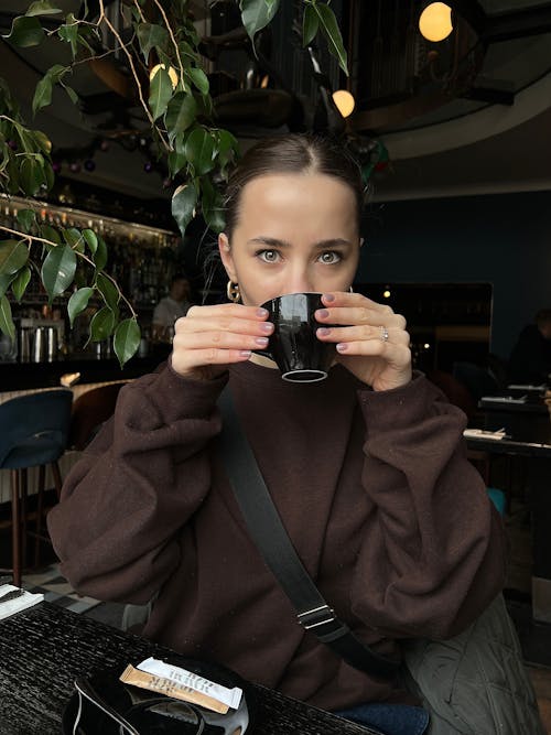 Woman Drinking from a Ceramic Cup