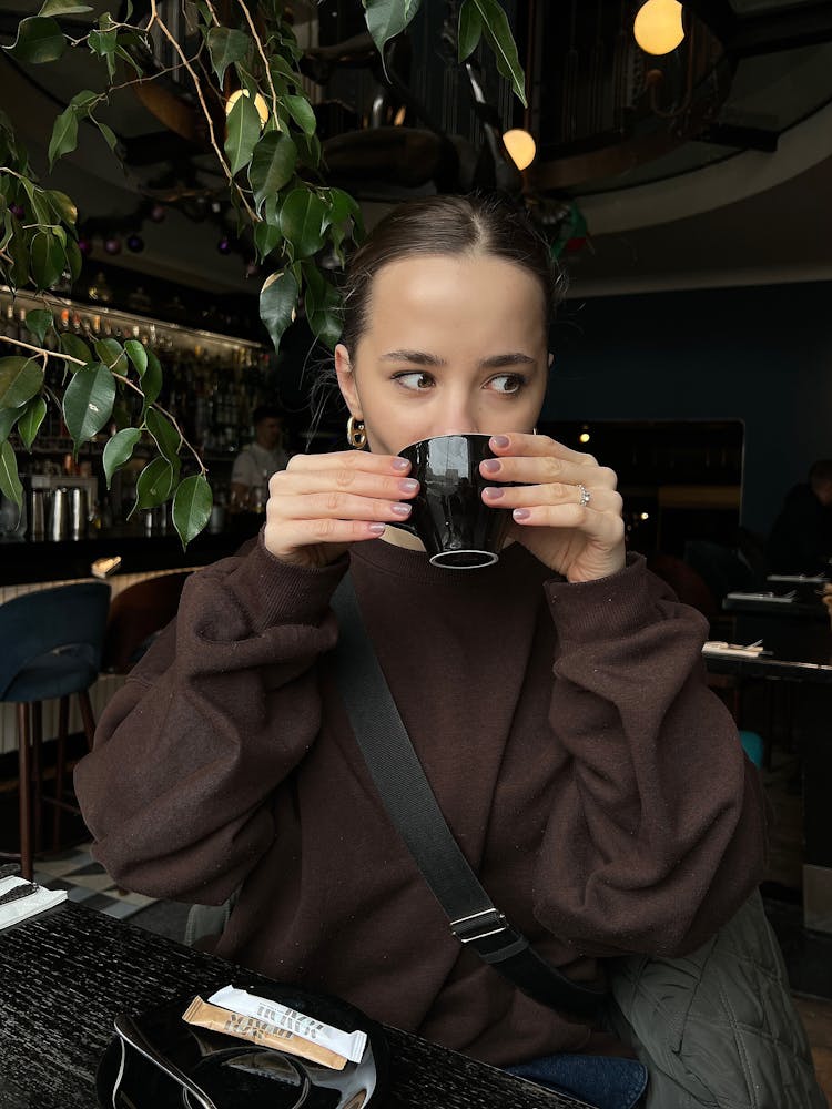 Woman Drinking From A Ceramic Cup