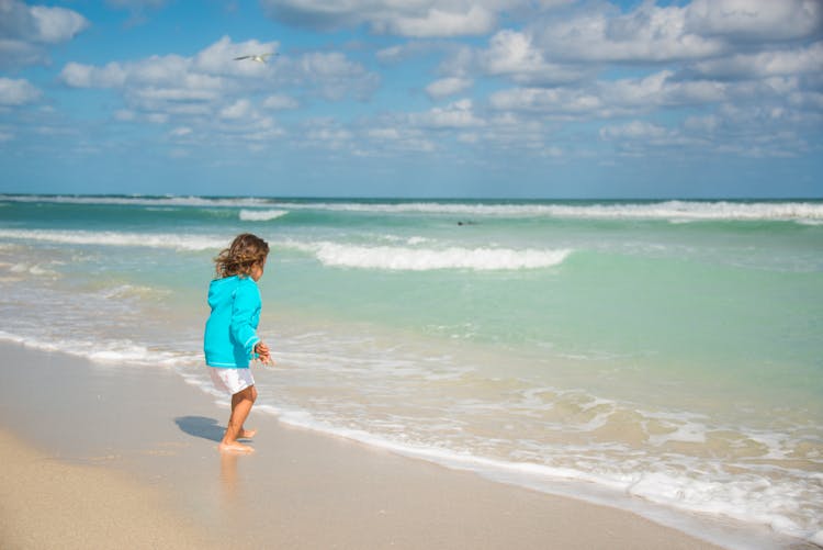 Child Running Into The Sea 