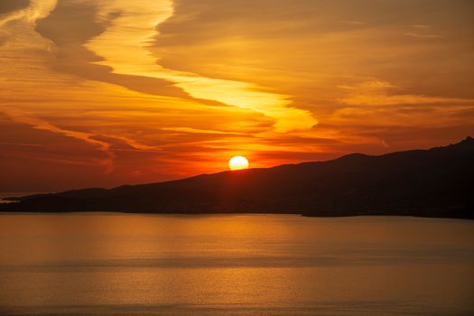 Captivating sunset over a peaceful sea with vibrant colors and clear horizon.