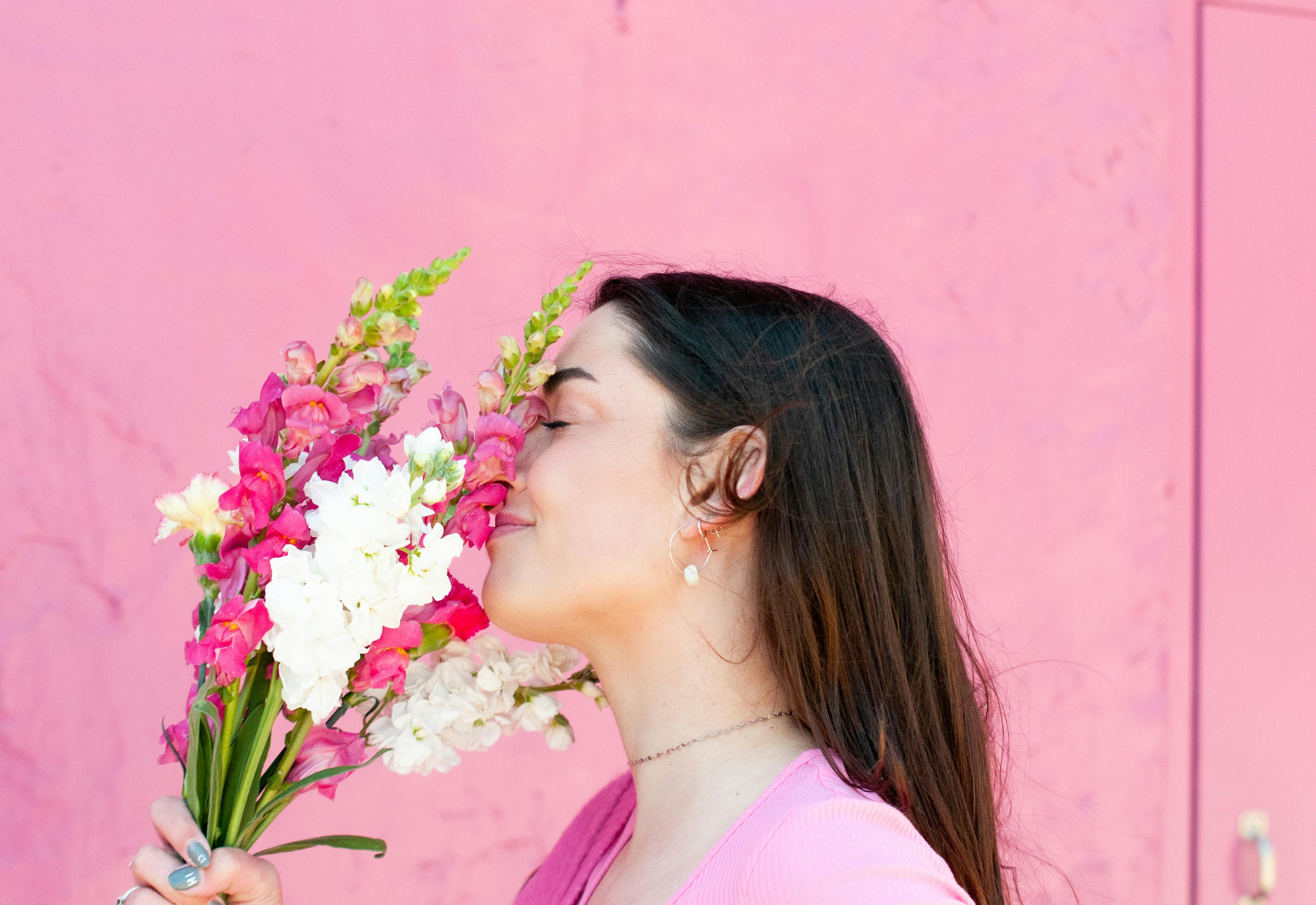 Smiling Woman Smelling Fragrant Flowers