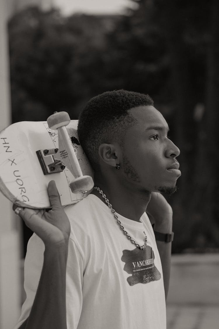 Young Man With Skateboard Outdoors