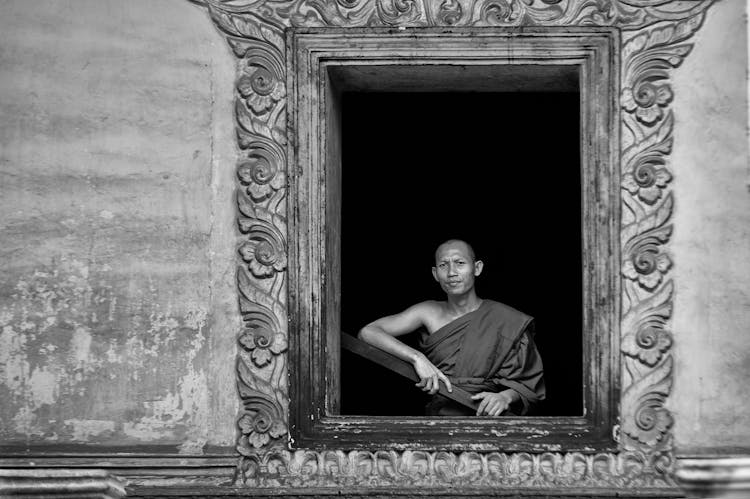 Monk In Building Window With Decoration