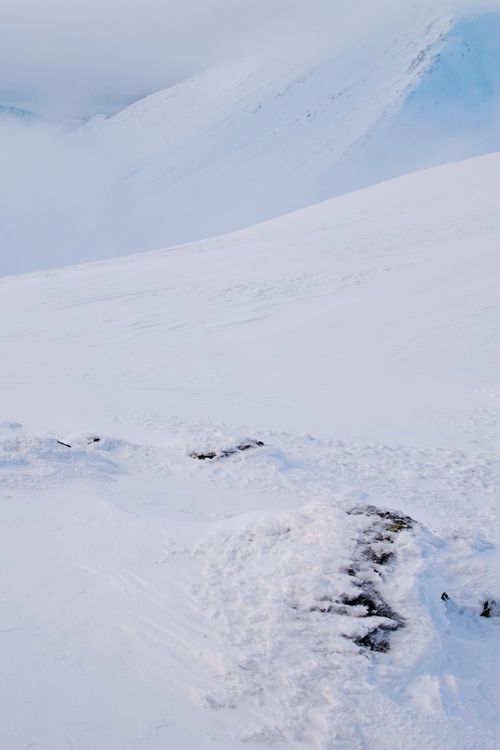 Free A breathtaking view of a snow-covered mountain range with rugged terrain. Stock Photo
