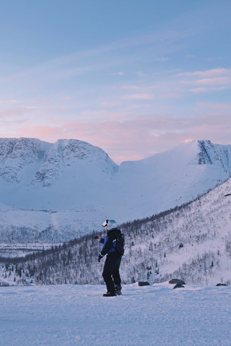 A Man Standing In Mountains