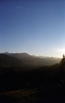 Peaceful mountain landscape with sunset and clear sky, ideal for travel and nature themes.