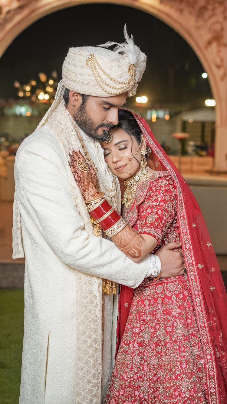 Bride And Groom In Traditional Costumes Hugging