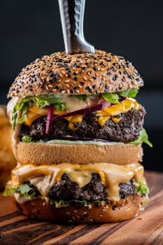 Delicious double cheeseburger with fresh toppings and sesame bun, ideal for fast food enthusiasts.