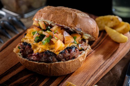Free Tasty Burger on Wooden Board Stock Photo