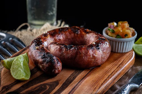Close-Up Photo of a Sausage on a Wooden Surface