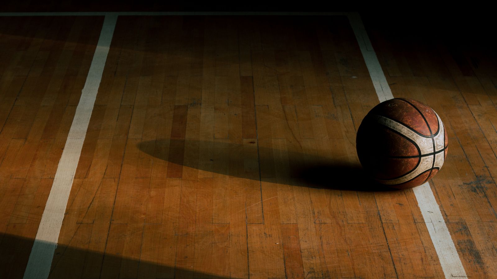 Representative licensed photograph of a basketball on an empty gym floor; not the Knicks, Pistons or October 27 game