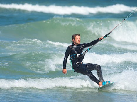 Exciting kitesurfing action with a man riding the waves in the ocean. Perfect water sports display.