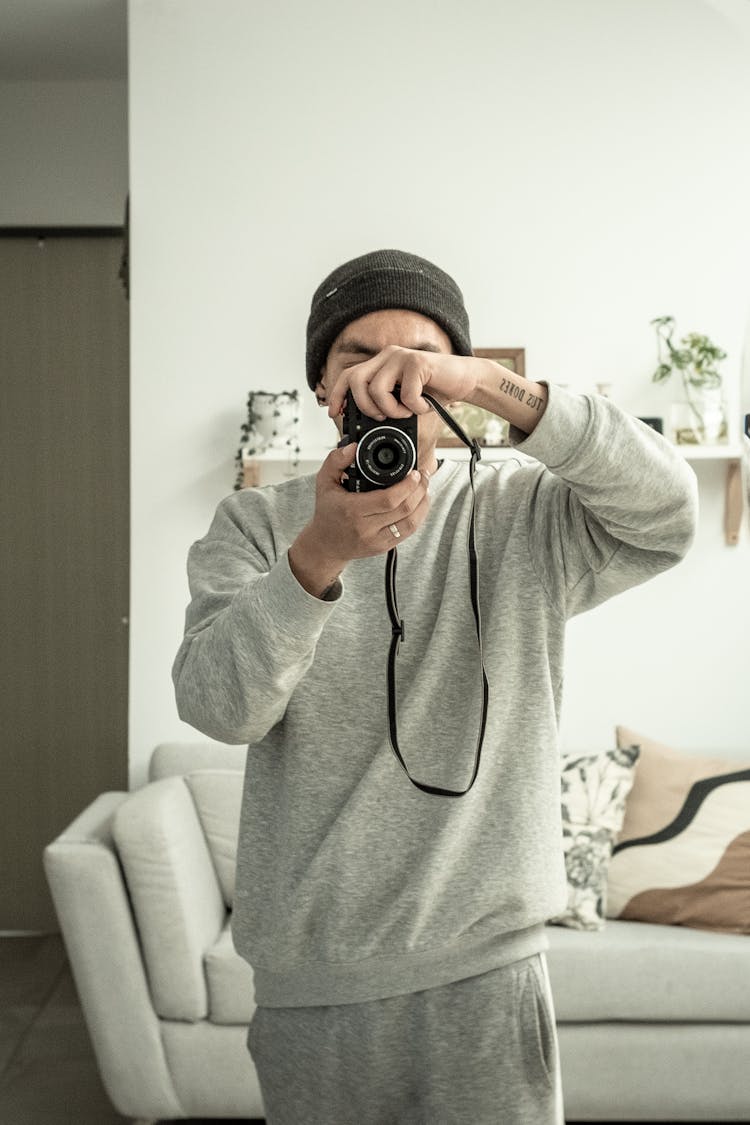 Man With Camera Photographing At Home