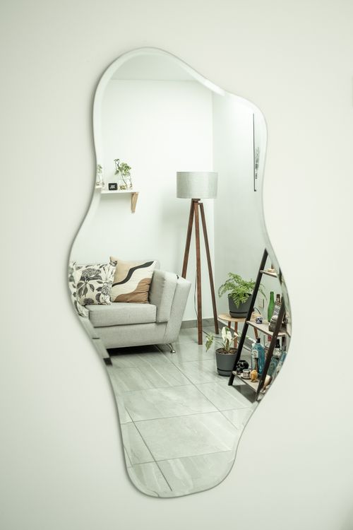 Free Stylish living room decor reflected in an abstract mirror, showcasing elegant interior design. Stock Photo