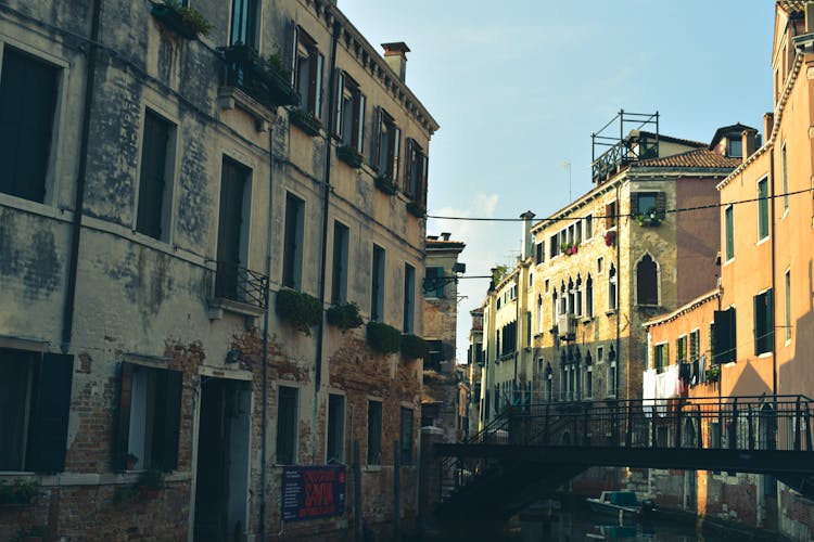 Townhouses And A Bridge Connecting Them Over The Canal In Venice