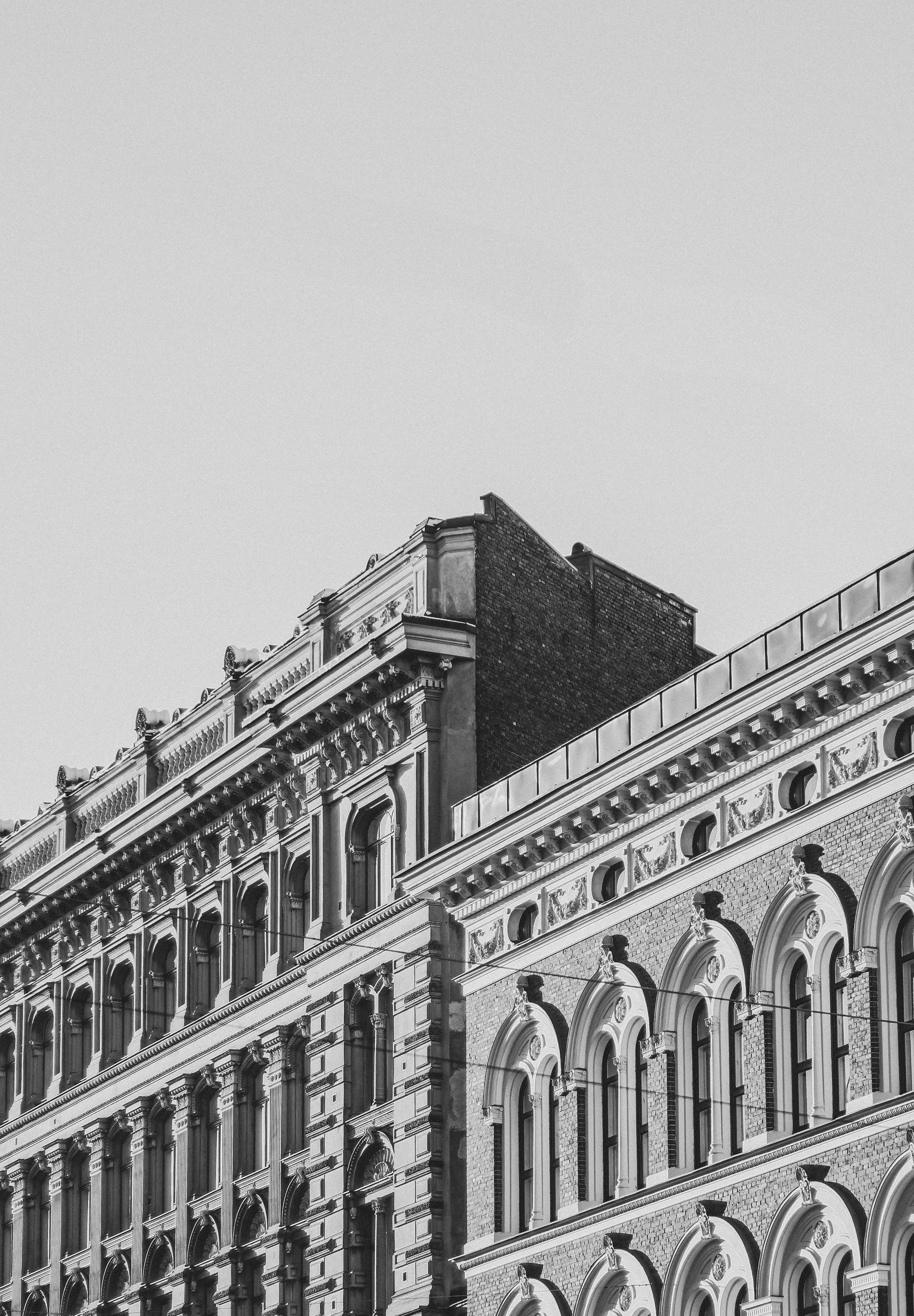 Ornate building facade in black and white showcasing elegant architectural details.