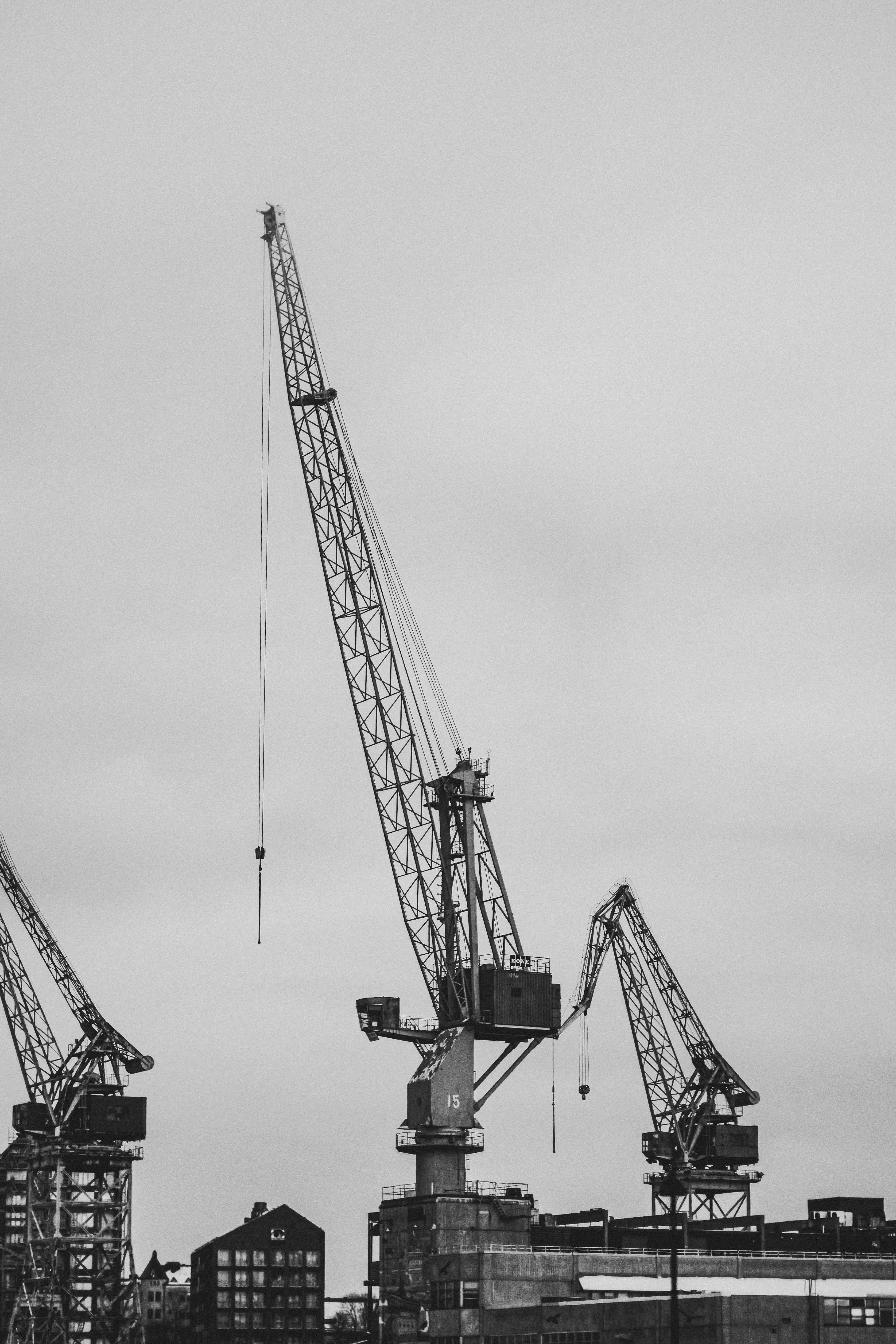Monochrome photograph of a crane at an industrial dockyard, highlighting machinery.