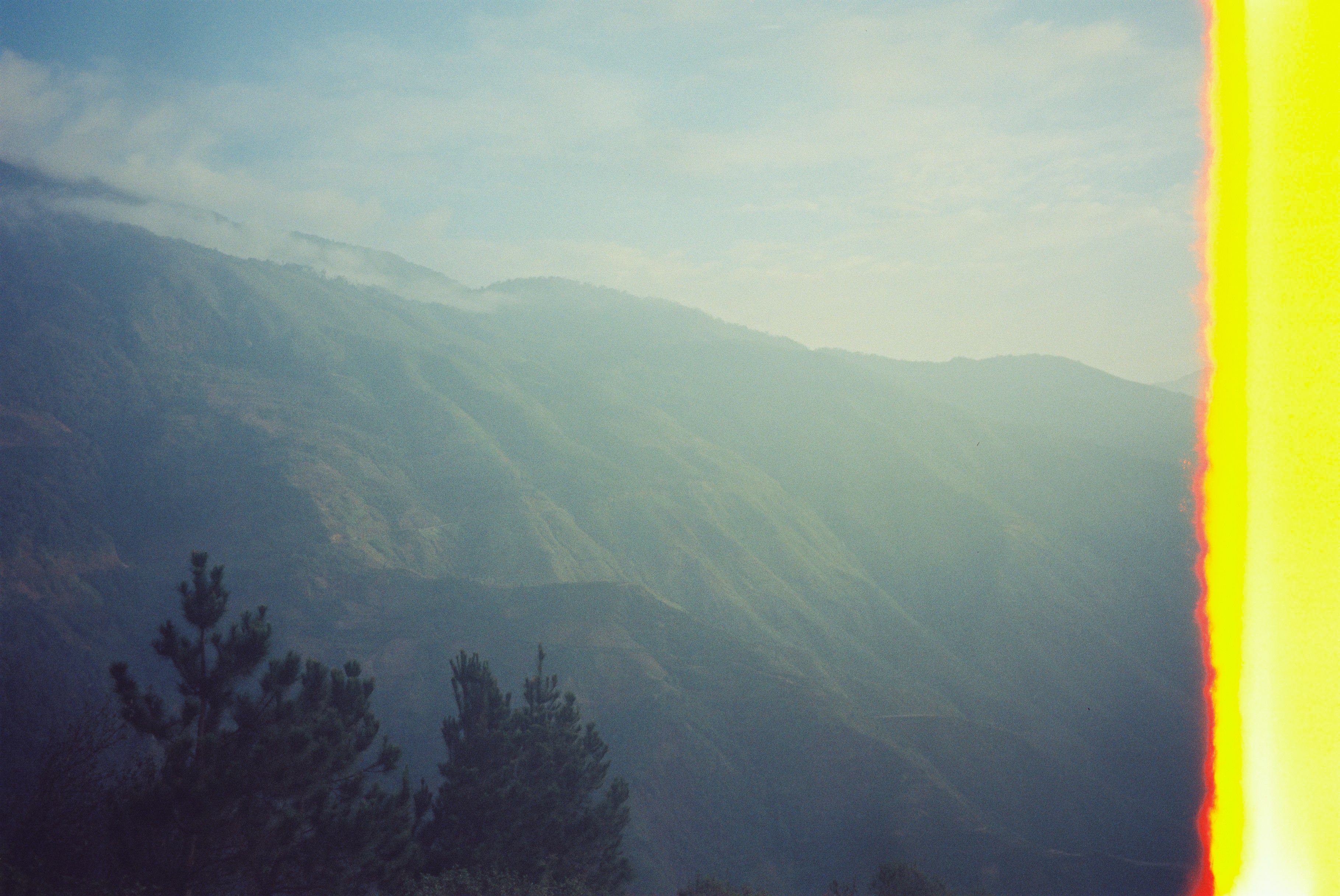 Mountain landscape covered in mist, analog film aesthetic