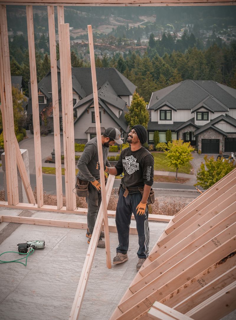 Carpenters framing a custom home on a sunny day