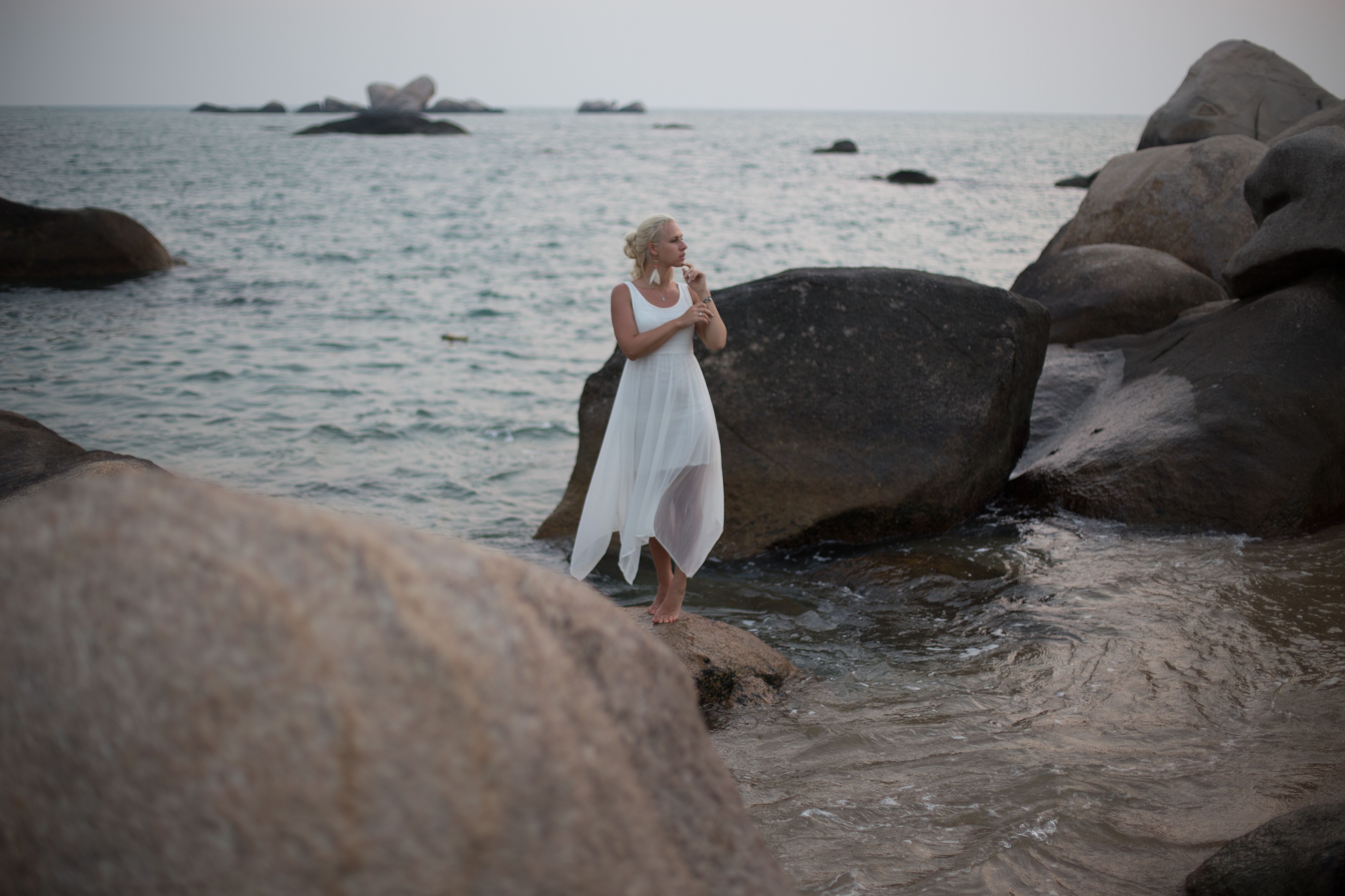 Model in a White Summer Dress Standing on a Rock in the Sea · Free ...